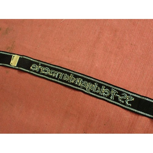 13 - WW2 SS-Feldgendarmerie cuff title

Aluminium wirework edging. The script is in a grey-silver-coloure... 