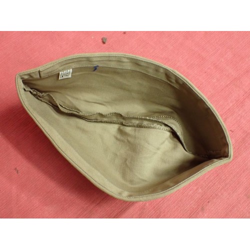 26 - U.S. Army WW2 garrison cap

Light tan cap. Good clean condition. With size label inside.