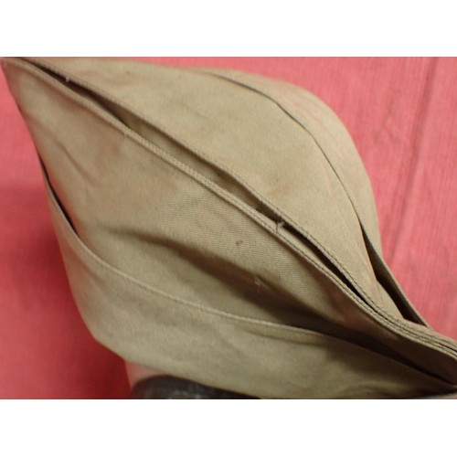 26 - U.S. Army WW2 garrison cap

Light tan cap. Good clean condition. With size label inside.