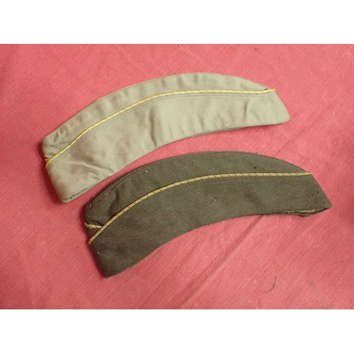 29 - U.S. WW2, two women's garrison caps

Caps with their size labels inside. The dark cap has some moth ... 
