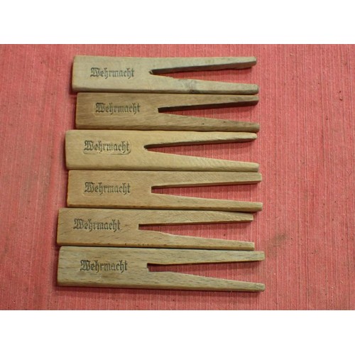 31 - WW2 German, six army marked clothing pegs

Wooden pegs with rounded edges. Around 110 mm