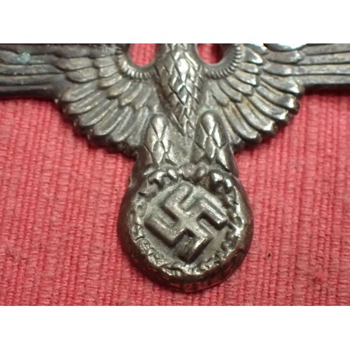 39 - WW2 German SS visor cap eagle badge

Nickel example. Missing one of its fixing pins. Grey patina