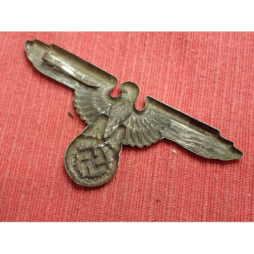 39 - WW2 German SS visor cap eagle badge

Nickel example. Missing one of its fixing pins. Grey patina