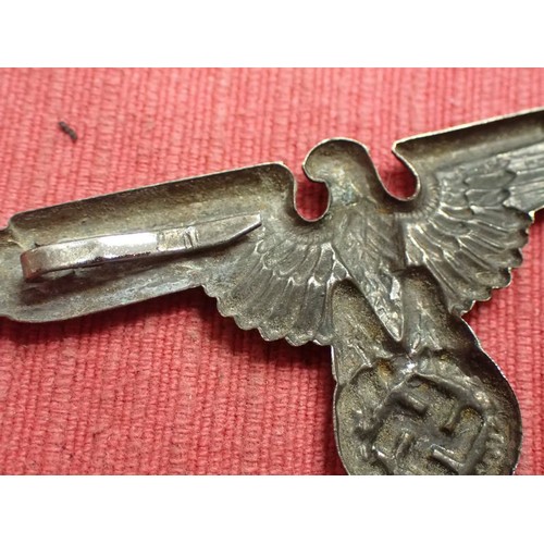 39 - WW2 German SS visor cap eagle badge

Nickel example. Missing one of its fixing pins. Grey patina