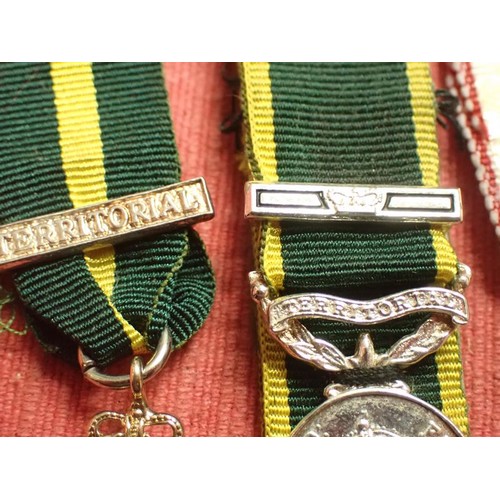 50 - British territorial medal minatures

Two territorial, and a ER2 1977 corronation medal