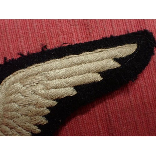 25 - WW1 British R.F.C. Observer's wing badge

Early cloth RFC observer wing with the elongated 