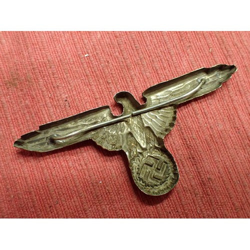 44 - WW2 German SS visor cap eagle

Nickel SS eagle. Both its fixing pins remain. Untouched patina.