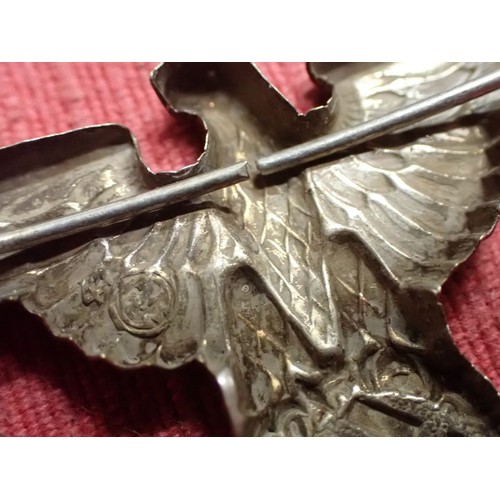 44 - WW2 German SS visor cap eagle

Nickel SS eagle. Both its fixing pins remain. Untouched patina.