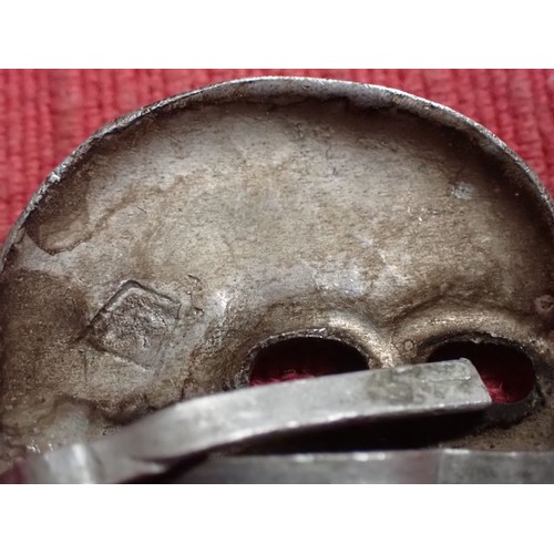 52 - WW2 German SS visor cap death's head badge

Die-stamped aluminium totenkopf. Untouched with a light ... 