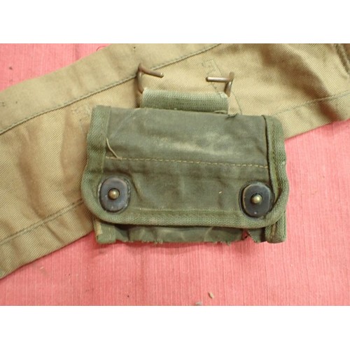 2 - 303 bandolier, a helmet camo net, a compass pouch

A 1956-dated 303 clip bandolier and a helmet net ... 