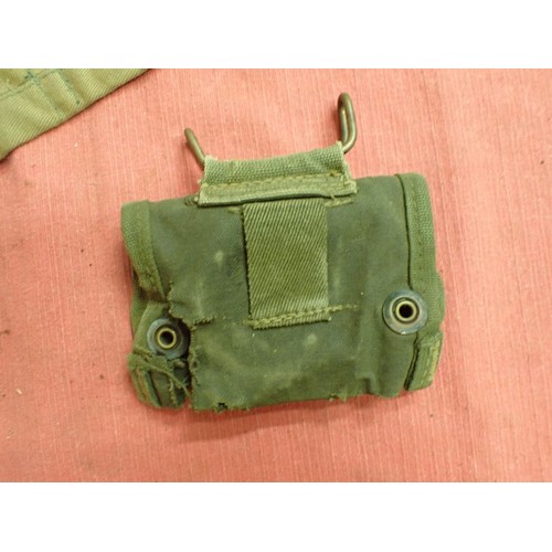 2 - 303 bandolier, a helmet camo net, a compass pouch

A 1956-dated 303 clip bandolier and a helmet net ... 