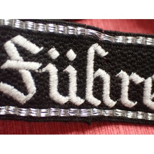 35 - WW2 Waffen-SS Der Fuhrer cuff title

Finely stitched white script. Folded and stitched ends. Traces ... 