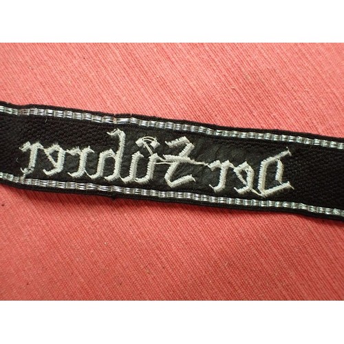 35 - WW2 Waffen-SS Der Fuhrer cuff title

Finely stitched white script. Folded and stitched ends. Traces ... 