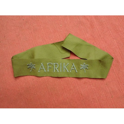 48 - WW2 German army AFRIKA cuff title

Thick grey/blue stitched script. The band is 435 mm long. Very go... 