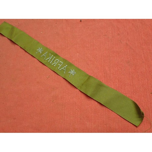 48 - WW2 German army AFRIKA cuff title

Thick grey/blue stitched script. The band is 435 mm long. Very go... 