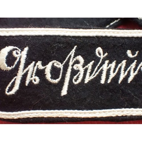 49 - WW2 German army Grossdeutschland cuff title

Stitched white script on a black woollen band. White bo... 