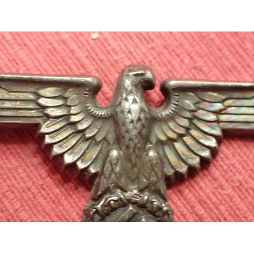 61 - WW2 German SS visor cap eagle

Turned to a dark grey patina. Both fixing pins remain to the back. Wi... 