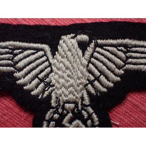 1 - WW2 German Waffen-SS sleeve eagle

Good clean condition. No moth nips to the black woollen backing
