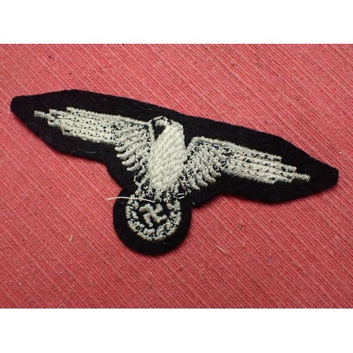 1 - WW2 German Waffen-SS sleeve eagle

Good clean condition. No moth nips to the black woollen backing