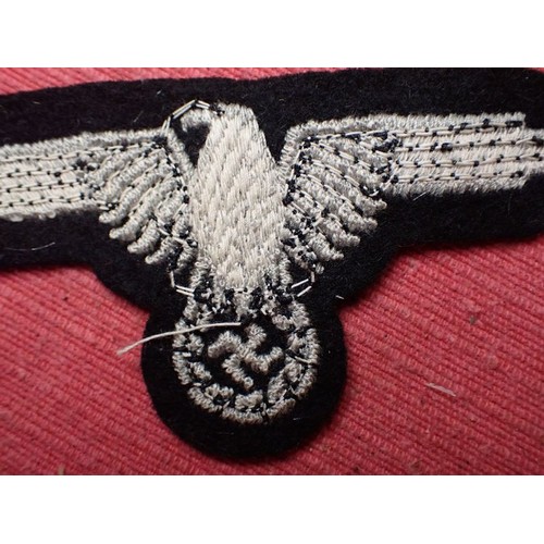 1 - WW2 German Waffen-SS sleeve eagle

Good clean condition. No moth nips to the black woollen backing