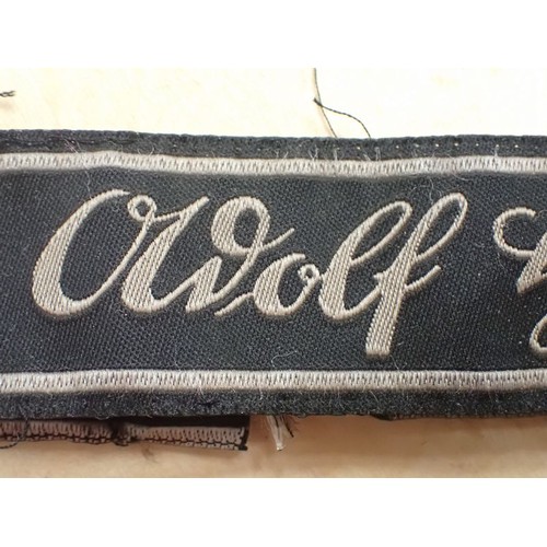 16 - WW2 German Waffen-SS Bevo Adolf hitler cuff title

Tunic removed Bevo title. 418 mm long. Some frayi... 