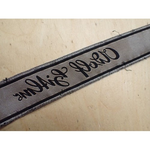 16 - WW2 German Waffen-SS Bevo Adolf hitler cuff title

Tunic removed Bevo title. 418 mm long. Some frayi... 