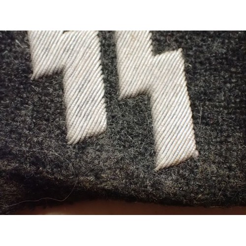 19 - WW2 German runic Waffen-SS collar tab

Tabin in well-worn condition. Some staining. Light frosted pa... 