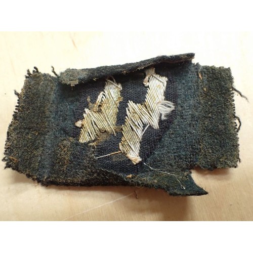 19 - WW2 German runic Waffen-SS collar tab

Tabin in well-worn condition. Some staining. Light frosted pa... 