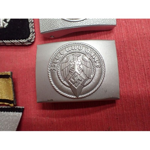27 - Selection of post war German badges and buckles

Seven reenactment items. The HJ buckle in silvered ... 