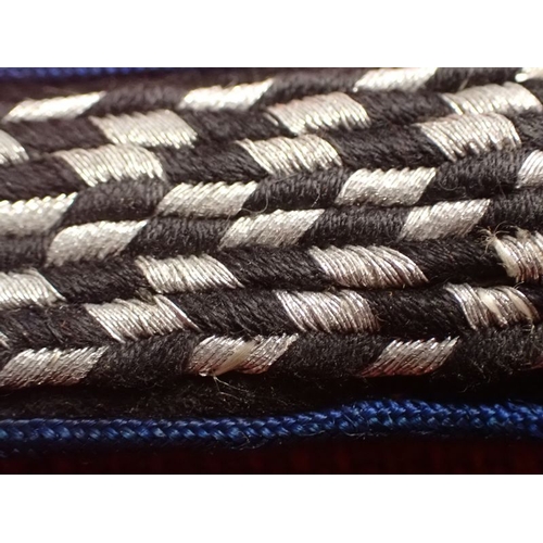 9 - WW2 German SA SHOULDER STRAP

BLUE EDGED STRAP WITH ALUMINUM WIRE TO THE FACING. 125 MM LONG