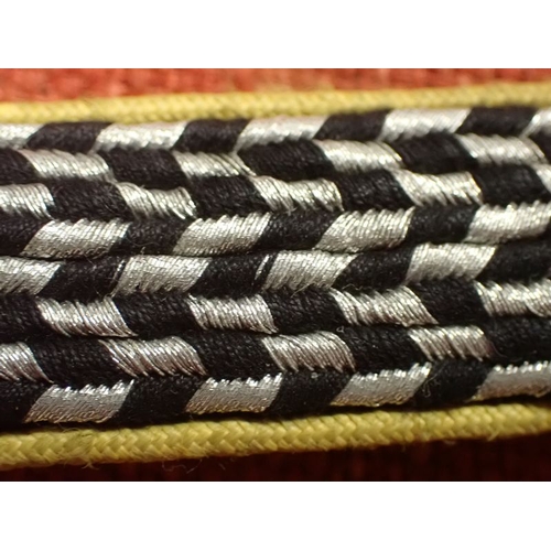 10 - WW2 German SA SHOULDER STRAP

YELLOW EDGED SLIM STRAP WITH ALUMINIUM WIRE AND BLACK FACING. 123 MM L... 