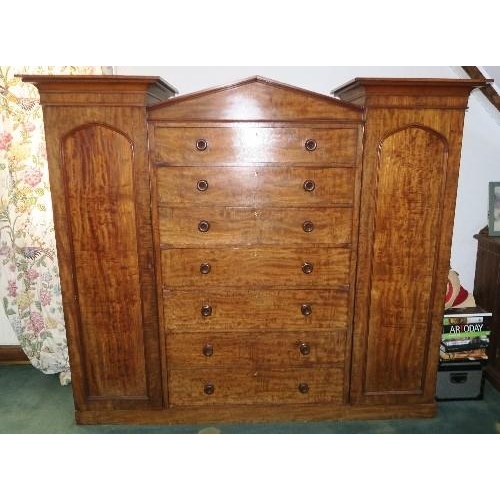 104 - A 19th century mahogany sentry box wardrobe, fitted with five long drawers over one deep long drawer... 