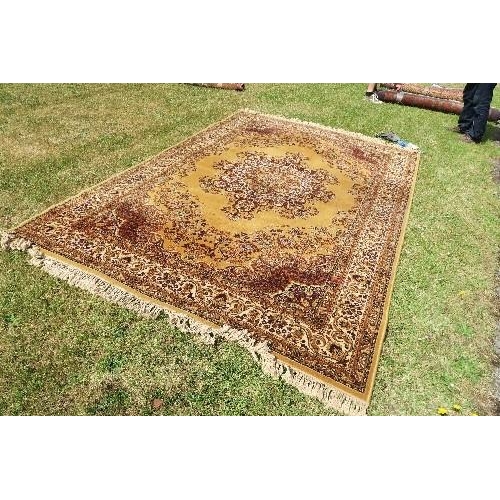 113 - AN EASTERN DESIGN MUSTARD GROUND RUG, 79INS X 116INS