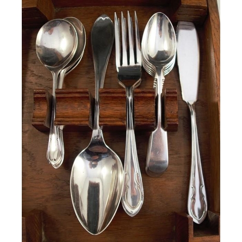 247 - An early 20th century silver plated part set of cutlery, in an oak carry case, the lid interior viny... 