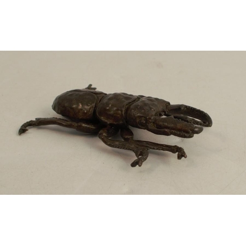 255 - A Japanese bronze model, of a stag beetle, signed, length 2.25ins