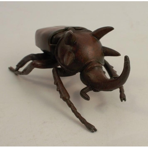 257 - A modern Japanese style bronze model, of a stag beetle, with hinged back, signed, length 4.5ins