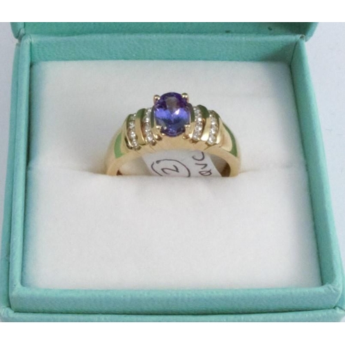 259 - A tanzanite and diamond 18 carat gold ring, the oval cut stone with channel set brilliants to each s... 