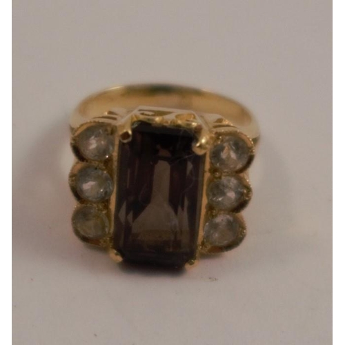 264 - A smoky quartz white stone dress ring, in unmarked yellow gold, tests as 18 carat gold, finger size ... 