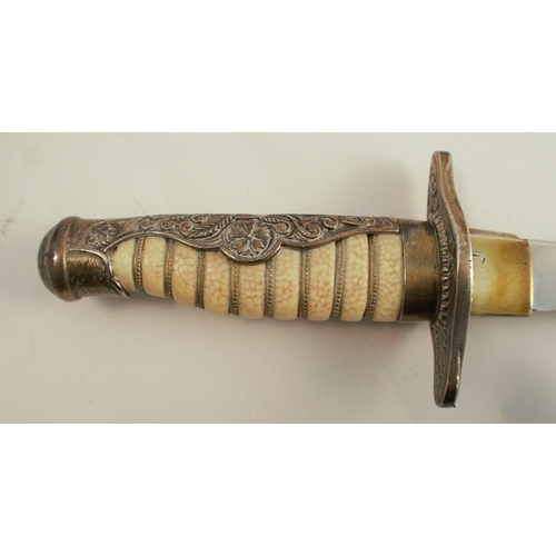 266 - A decorative dagger and sheath, with shagreen effect handle and brass mounts, the leather sheath wit... 