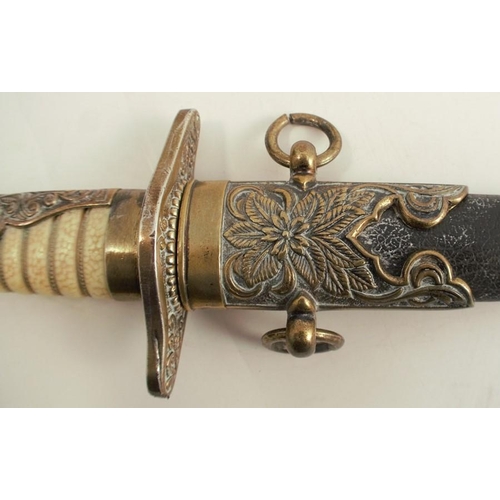 266 - A decorative dagger and sheath, with shagreen effect handle and brass mounts, the leather sheath wit... 