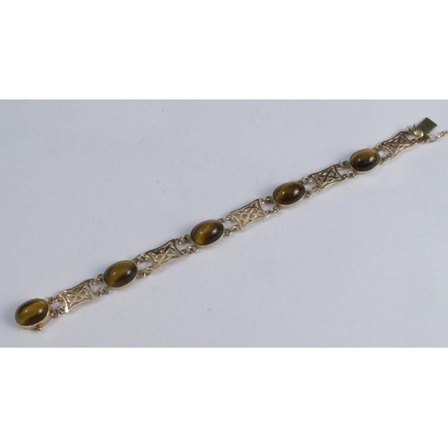 276 - A 9 carat gold tiger eye bracelet, the five cabochons with pierced panels between, 19cm long, 16g gr... 