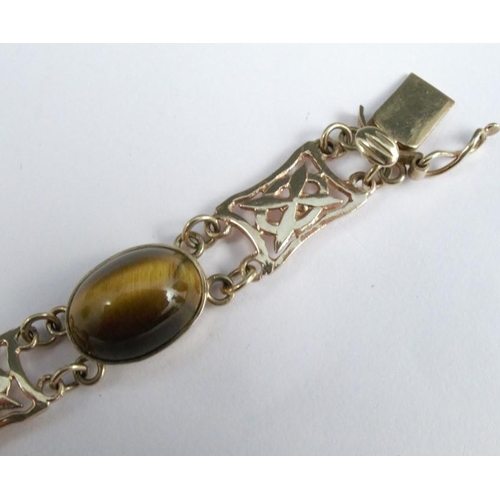 276 - A 9 carat gold tiger eye bracelet, the five cabochons with pierced panels between, 19cm long, 16g gr... 