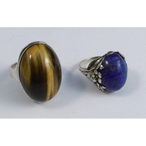 279 - A lapis lazuli ring in the style of Bernard Istone, together with a silver tiger eye ring