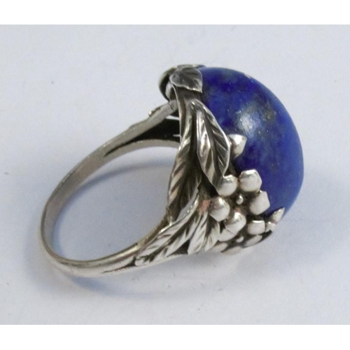 279 - A lapis lazuli ring in the style of Bernard Istone, together with a silver tiger eye ring