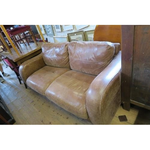 60 - A LEATHER TWO SEATER SOFA with fire labels