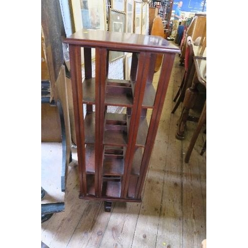 66 - A REVOLVING BOOK STAND, 15INS X 12INS X HEIGHT 39INS