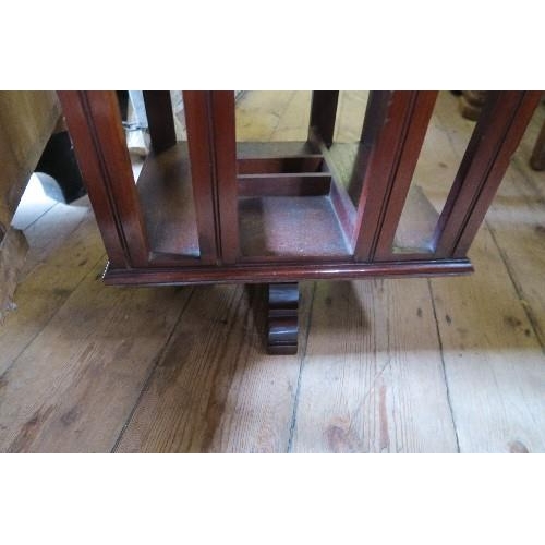 66 - A REVOLVING BOOK STAND, 15INS X 12INS X HEIGHT 39INS