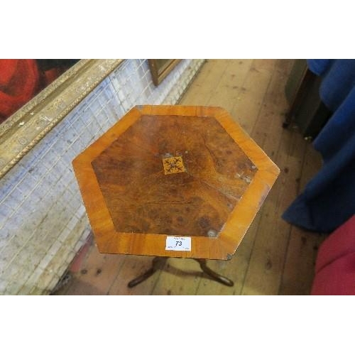 73 - AN HEXAGONAL TOPPED OCCASIONAL TABLE, RAISED ON A TRIPOD BASE, HEIGHT 70INS X MAX WIDTH 15.75INS