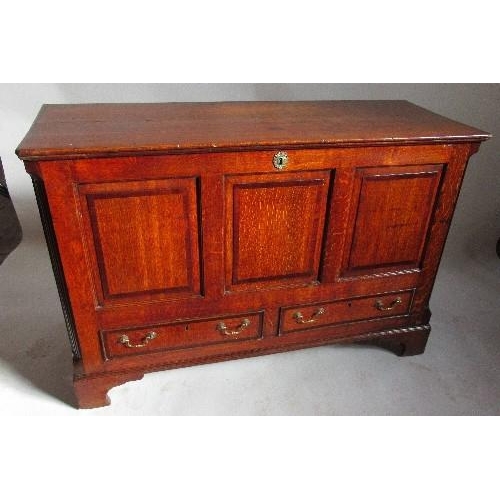 74 - An Antique oak mule chest, with rising lid over a three panelled front and two drawers, width 53.5in... 