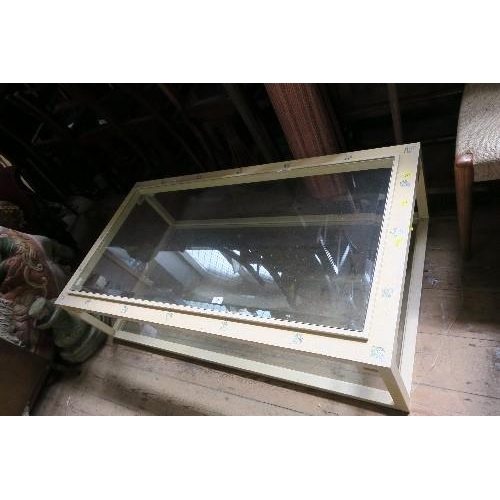 95 - A GLASS TOP COFFEE TABLE, 55INS X 29INS X HEIGHT 15INS